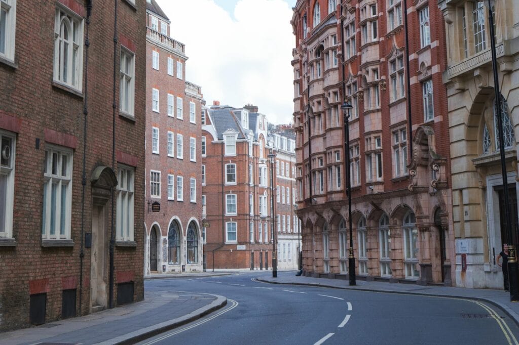 An empty street of British townhouses.