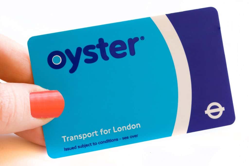 A cropped photo of a woman holding an Oyster card