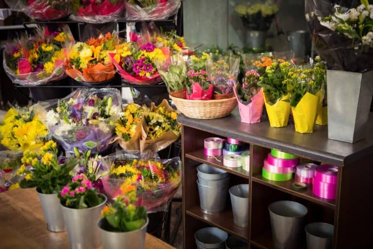 Flower vase arranged in a wooden worktop in a flower shop in the concept of local shops and markets in Romford.